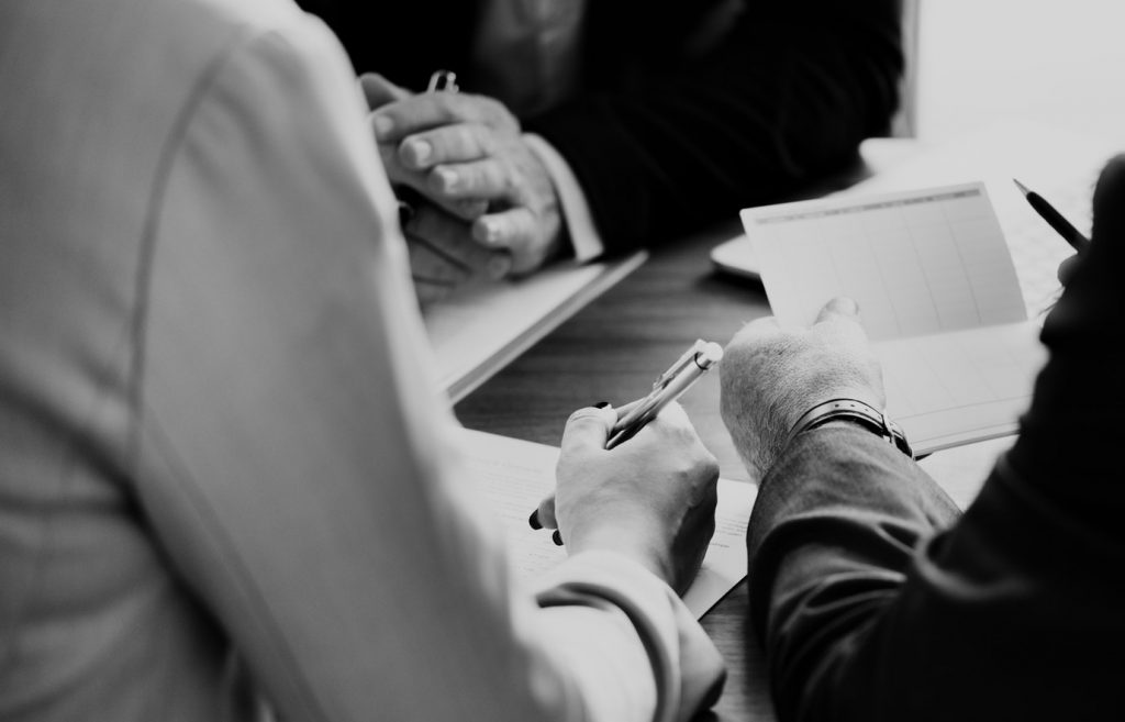 People sitting down and filling out paperwork