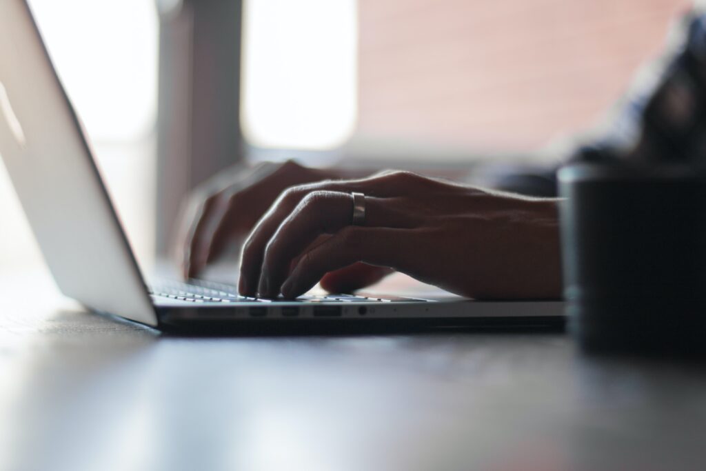 person filing for bankruptcy typing on a laptop