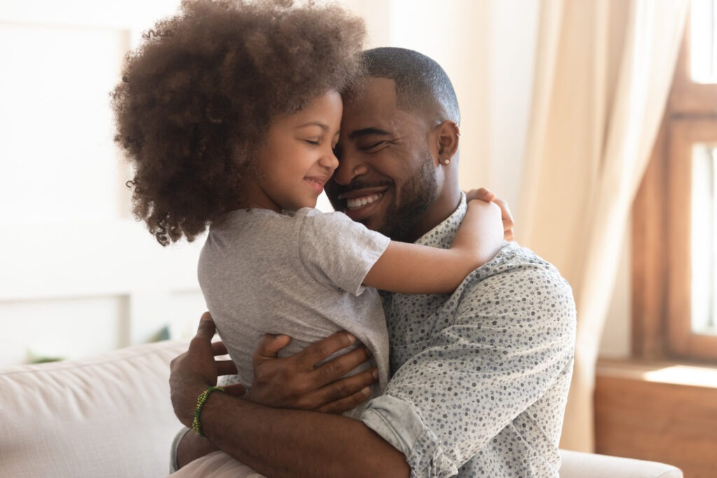 Father hugging his young daughter