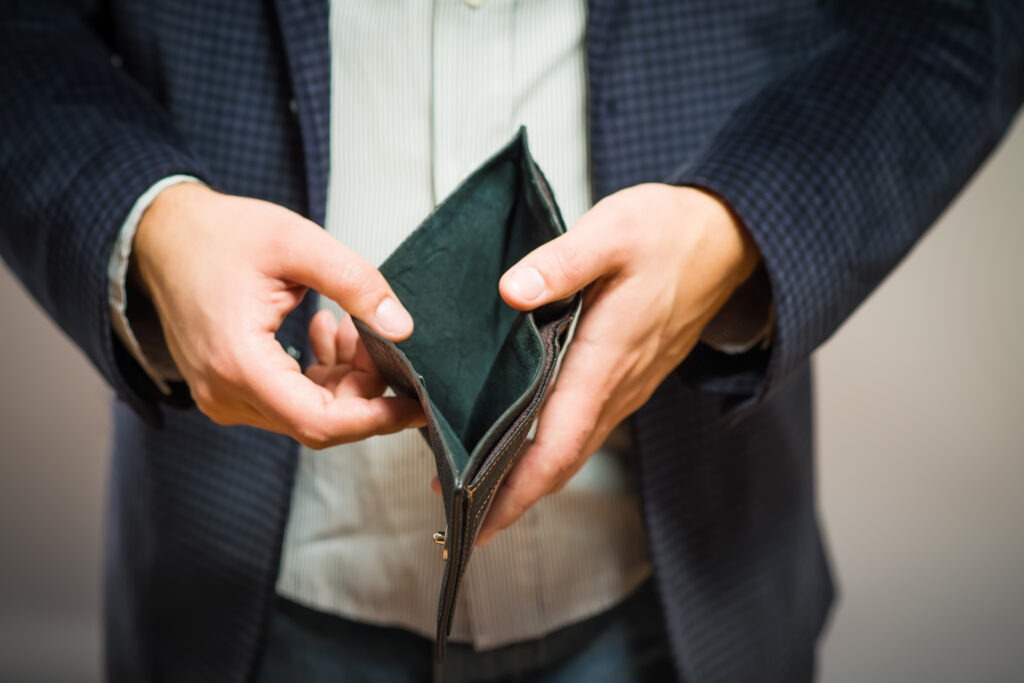 Bankruptcy - Business Person holding an empty wallet