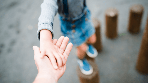child holding parents hand