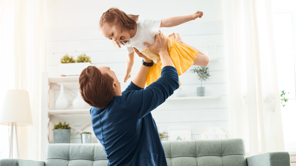 Father holding up child in air